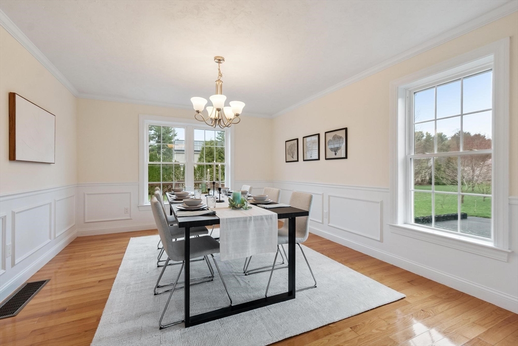 4 Henley Road Acton, MA 01720 - Photo 12 of 32 a dining room with wooden floor a glass table and chairs