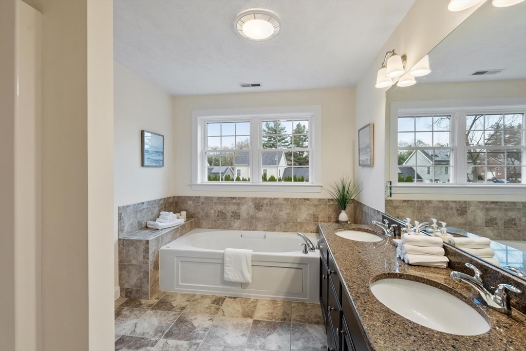 4 Henley Road Acton, MA 01720 - Photo 23 of 32 a bathroom with a tub sink and window