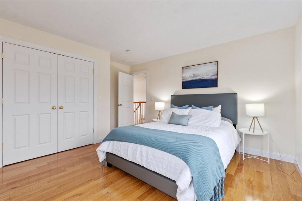 4 Henley Road Acton, MA 01720 - Photo 27 of 32 a bedroom with a bed and a night stand