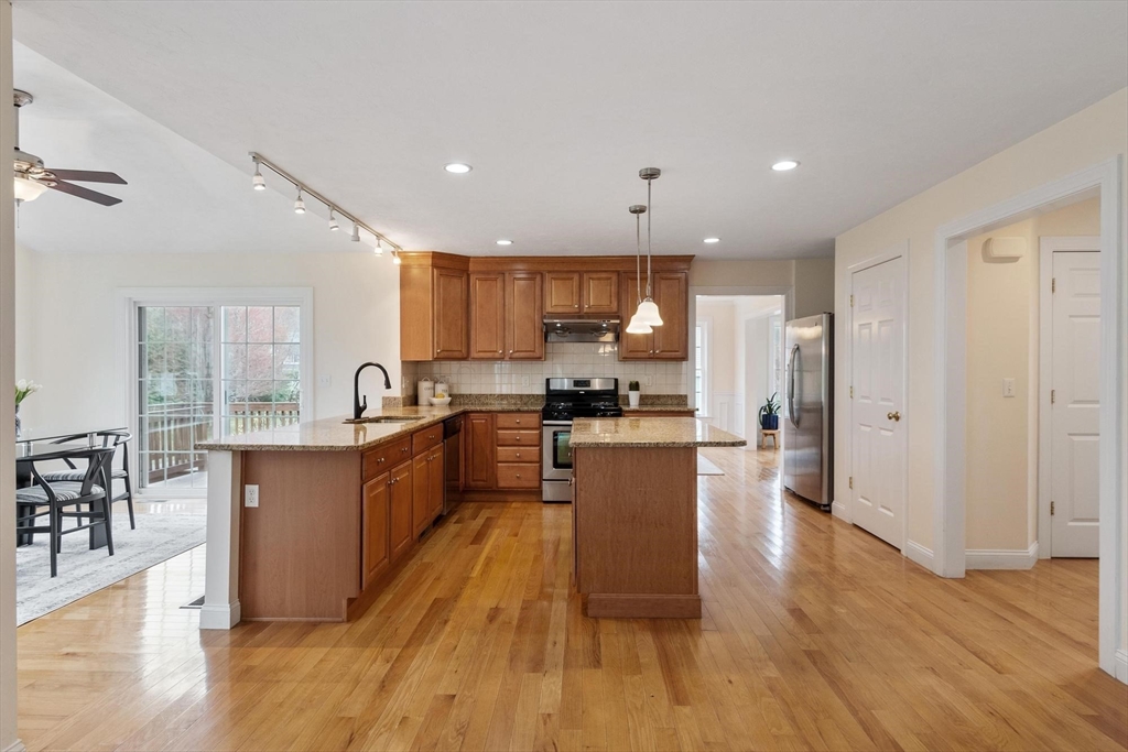 4 Henley Road Acton, MA 01720 - Photo 4 of 32 a large kitchen with stainless steel appliances refrigerator a stove top oven and wooden floors