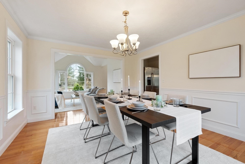 4 Henley Road Acton, MA 01720 - Photo 10 of 32 a view of a dining room with furniture a chandelier and wooden floor