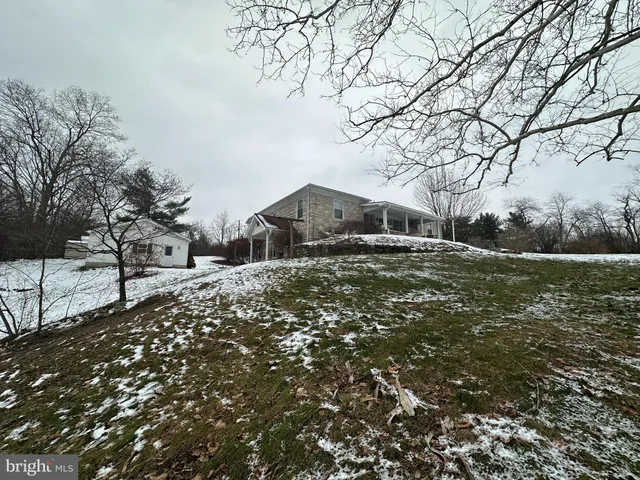 a view of a house with a snow on the road