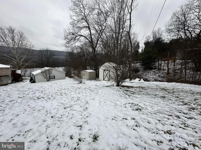 a living room with furniture a lamp and a window