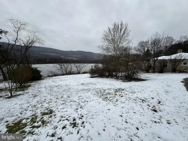 a bathroom with a sink a bathtub and next to a window