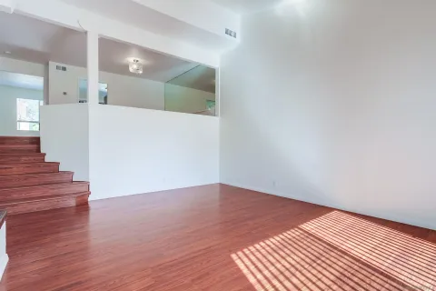 a view of a hallway with wooden floor