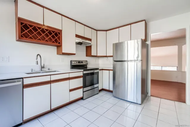 a kitchen with stainless steel appliances a refrigerator sink and cabinets