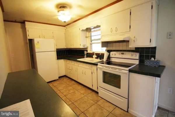 a kitchen with stainless steel appliances a stove a refrigerator sink and cabinets