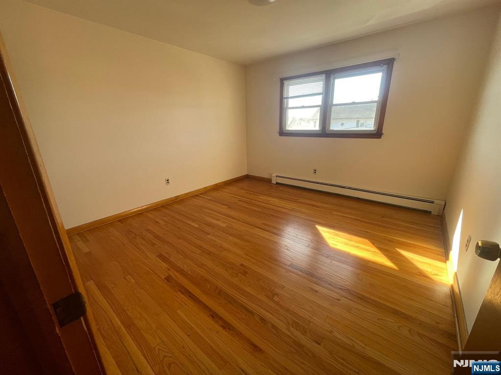 435 Taylor Avenue, Unit 2 South Hackensack, NJ 07606 - Photo 2 of 6 a view of empty room with wooden floor and fan