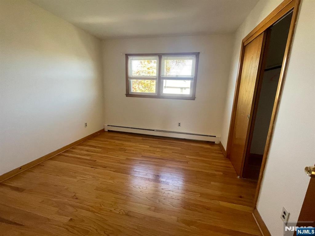 435 Taylor Avenue, Unit 2 South Hackensack, NJ 07606 - Photo 4 of 6 a view of empty room with wooden floor and fan
