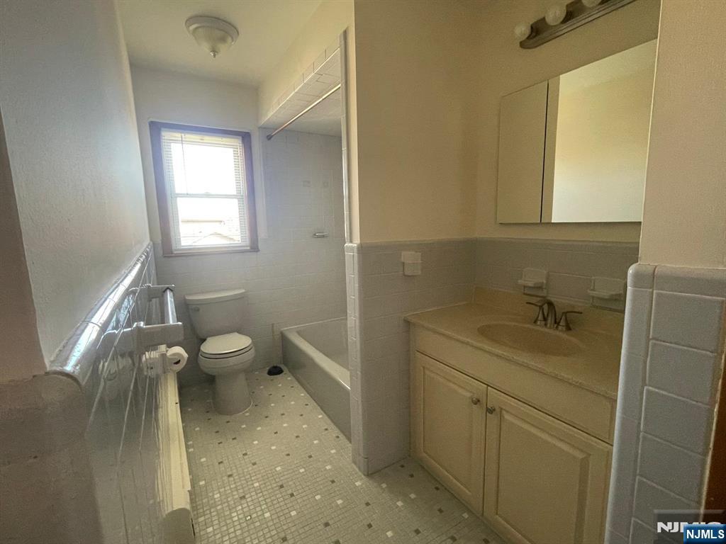 435 Taylor Avenue, Unit 2 South Hackensack, NJ 07606 - Photo 6 of 6 a bathroom with a sink toilet and window