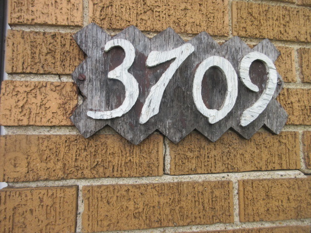3709 West 66th Place Chicago, IL 60629 - Photo 7 of 8 a bathroom with a granite countertop sink and a mirror