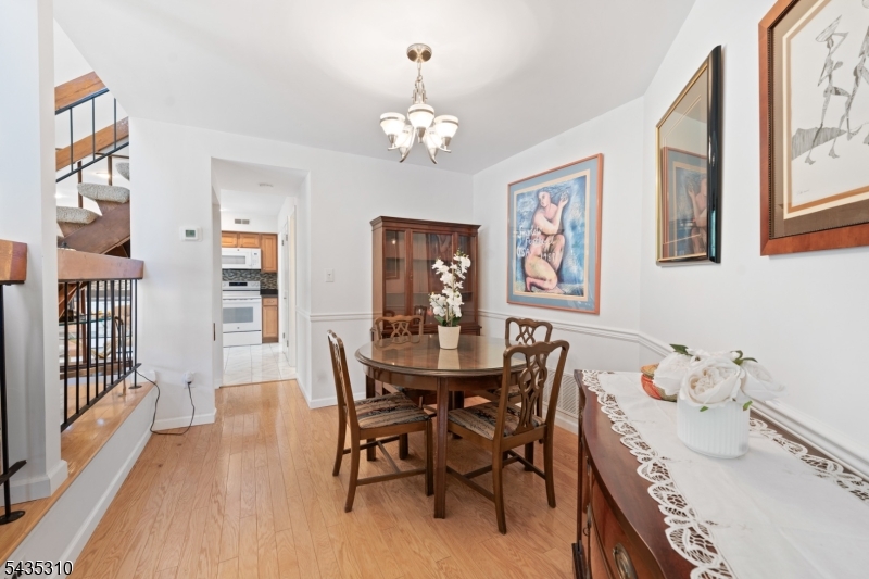 488 Auten Road, Unit 2D Hillsborough, NJ 08844 - Photo 8 of 30 a view of a dining room with furniture wooden floor and chandelier