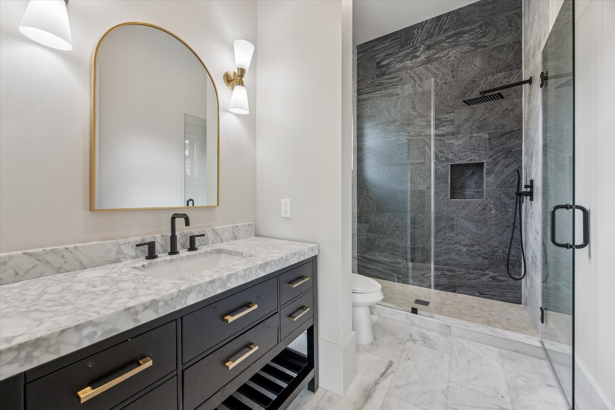 7203 Tickner Street Houston, TX 77055 - Photo 34 of 43 a bathroom with a granite countertop sink a mirror and shower