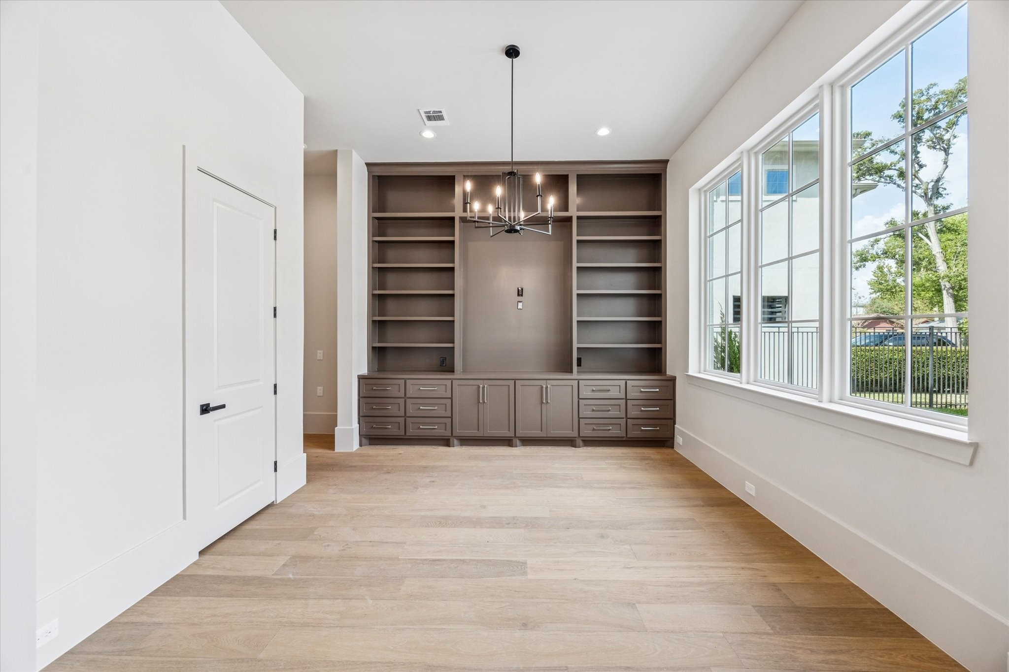 7203 Tickner Street Houston, TX 77055 - Photo 6 of 43 a view of a hallway with wooden shelves and a window