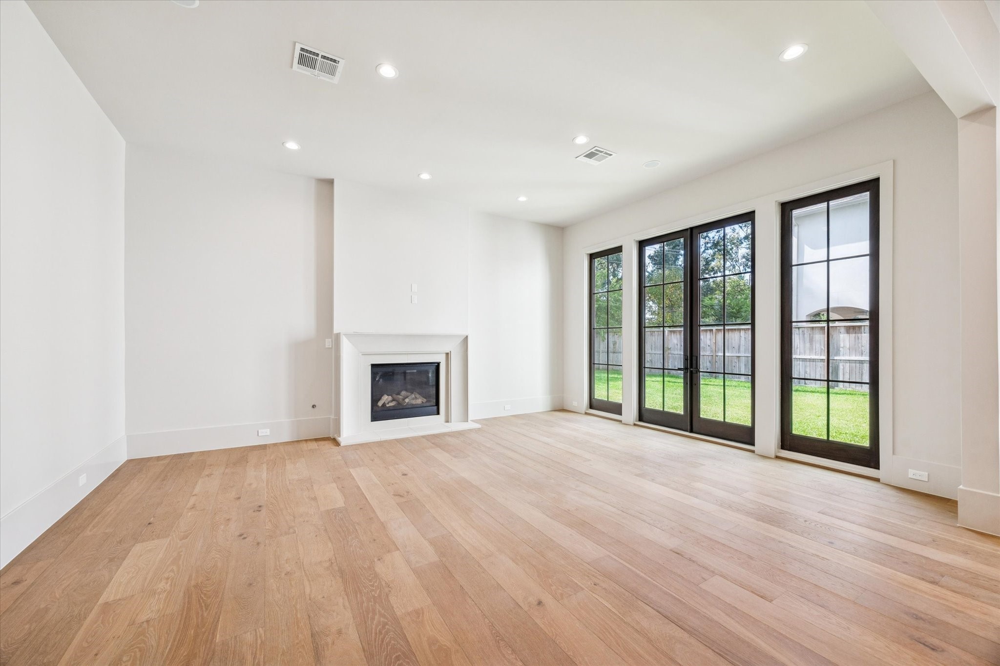 7203 Tickner Street Houston, TX 77055 - Photo 10 of 43 a view of empty room with wooden floor and fireplace