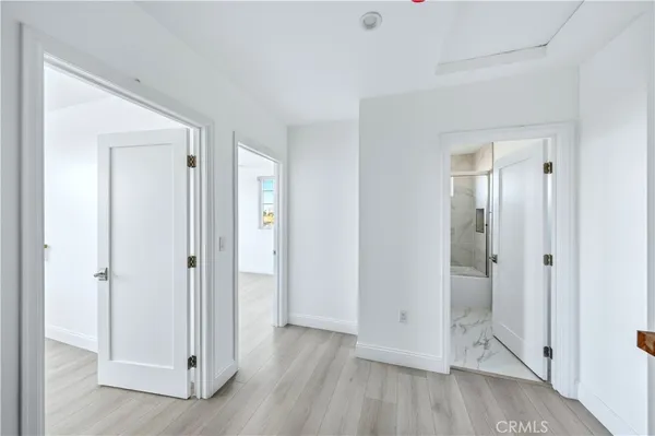 an empty room with wooden floor and window