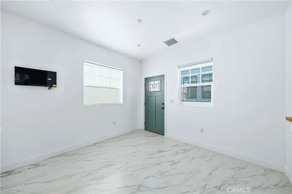 an empty room with windows and closet