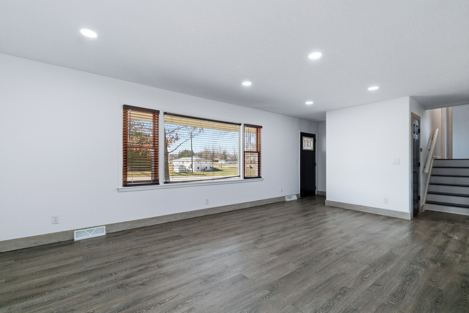 11622 27th Street West Milan, IL 61264 - Photo 16 of 49 an empty room with wooden floor and window