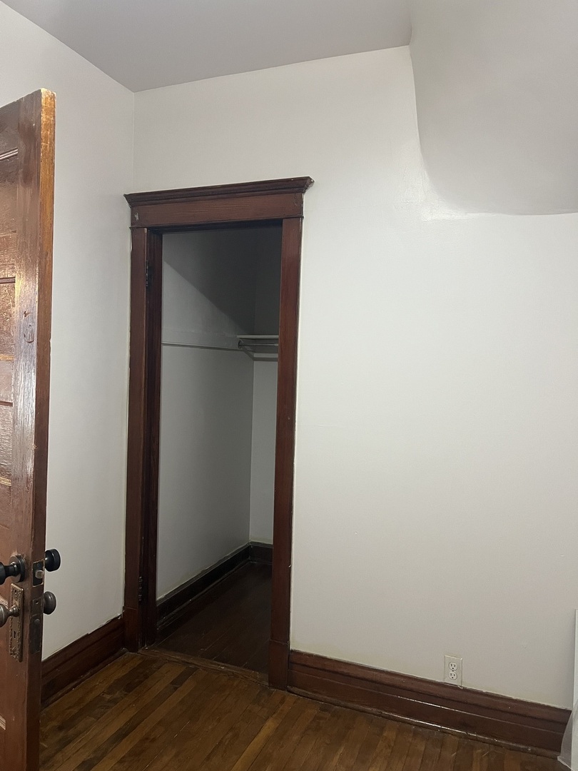 1921 North Pulaski Road, Unit 1 Chicago, IL 60639 - Photo 12 of 16 a view of empty room with wooden floor and fan