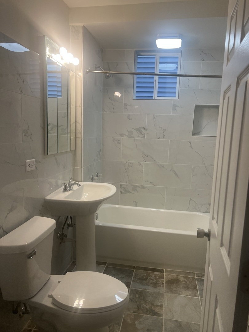1921 North Pulaski Road, Unit 1 Chicago, IL 60639 - Photo 14 of 16 a bathroom with a toilet a sink and bathtub