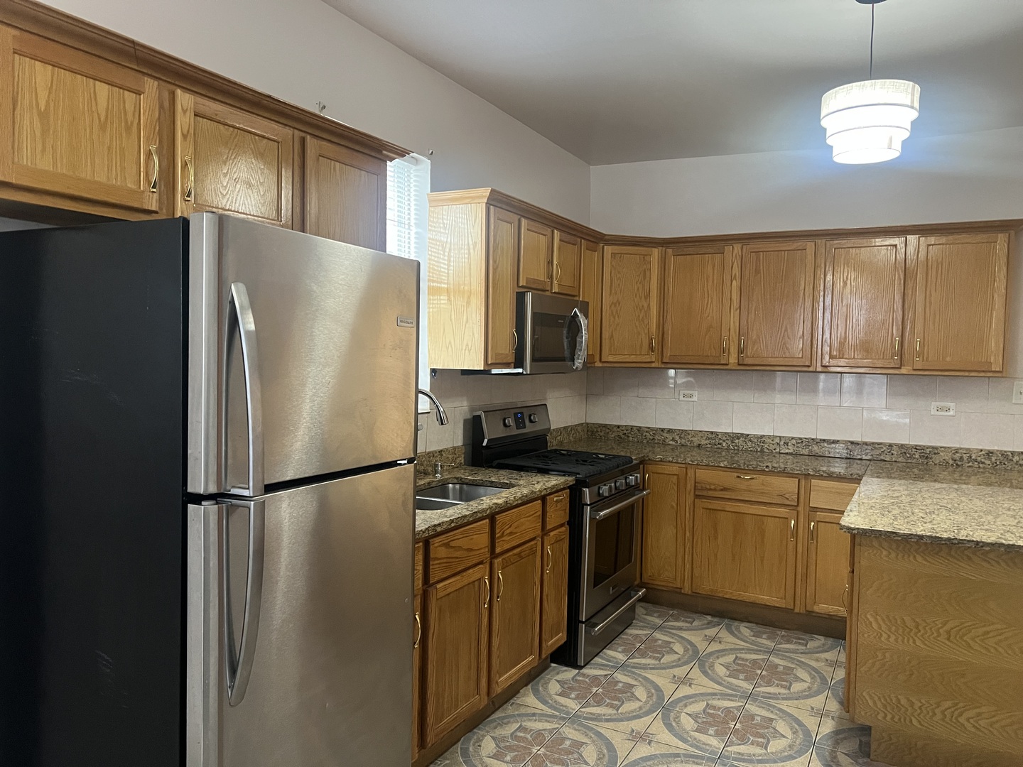 1921 North Pulaski Road, Unit 1 Chicago, IL 60639 - Photo 7 of 16 a kitchen with stainless steel appliances granite countertop a refrigerator a stove a sink and a microwave