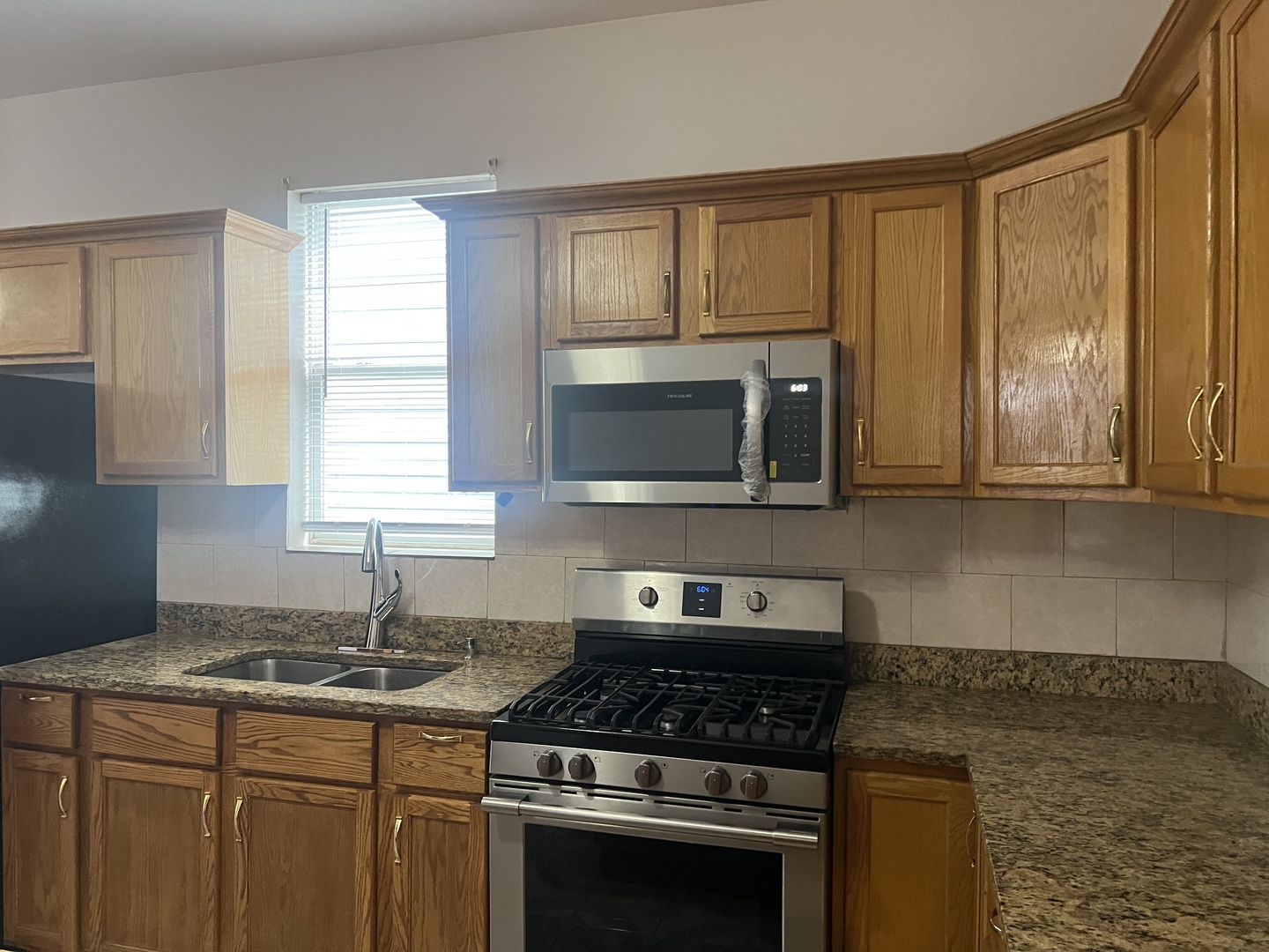 1921 North Pulaski Road, Unit 1 Chicago, IL 60639 - Photo 8 of 16 a kitchen with granite countertop a stove sink and cabinets