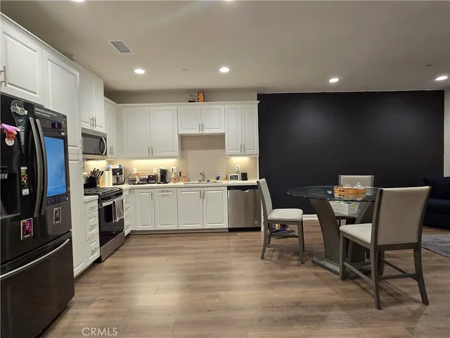 a kitchen with a sink cabinets and stainless steel appliances