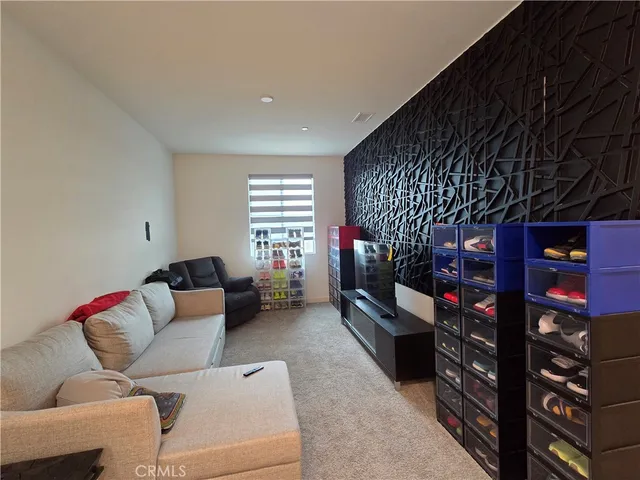 a living room with furniture a window and a flat screen tv