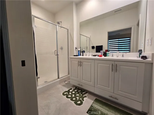 a kitchen with white cabinets and sink