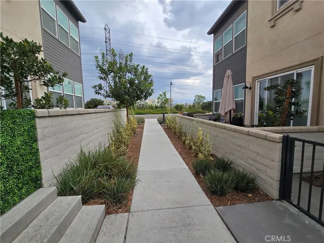 a view of a pathway both side of the house