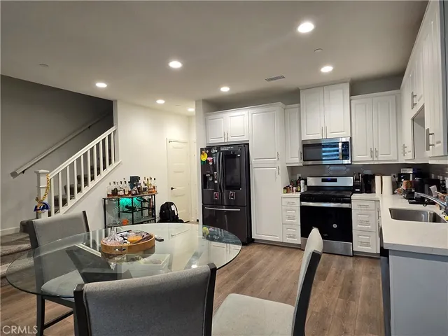 a living room with stainless steel appliances furniture or couch and a kitchen