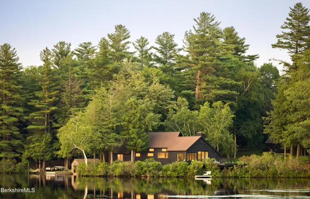 an aerial view of a house with garden space and lake view