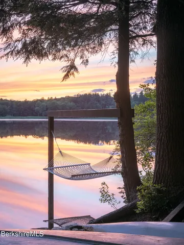 a view of a living room with a floor to ceiling window and wooden floor
