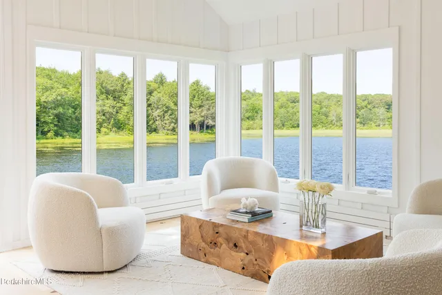 a living room with fireplace and furniture