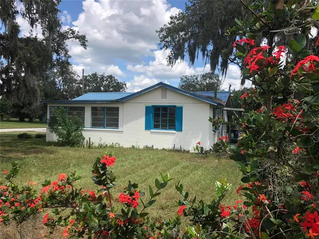 a view of a house with yard and a garden