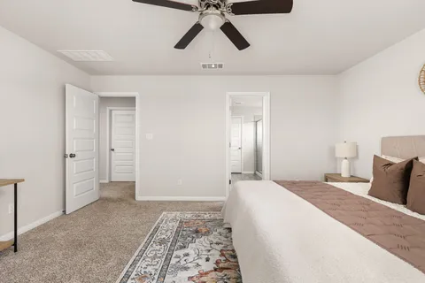 a bedroom with a bed and painting on the wall