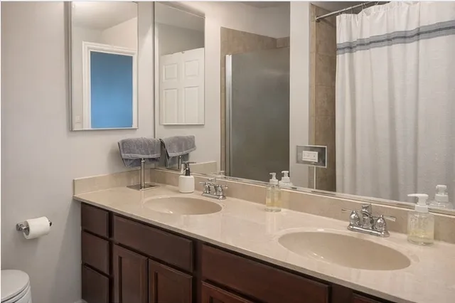 a bathroom with a sink double vanity and a mirror
