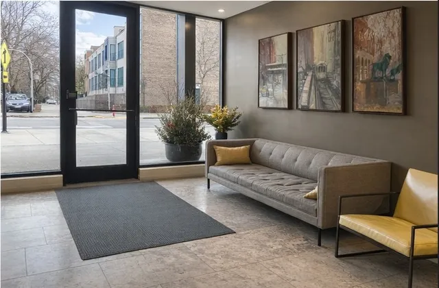 a living room with furniture and a floor to ceiling window