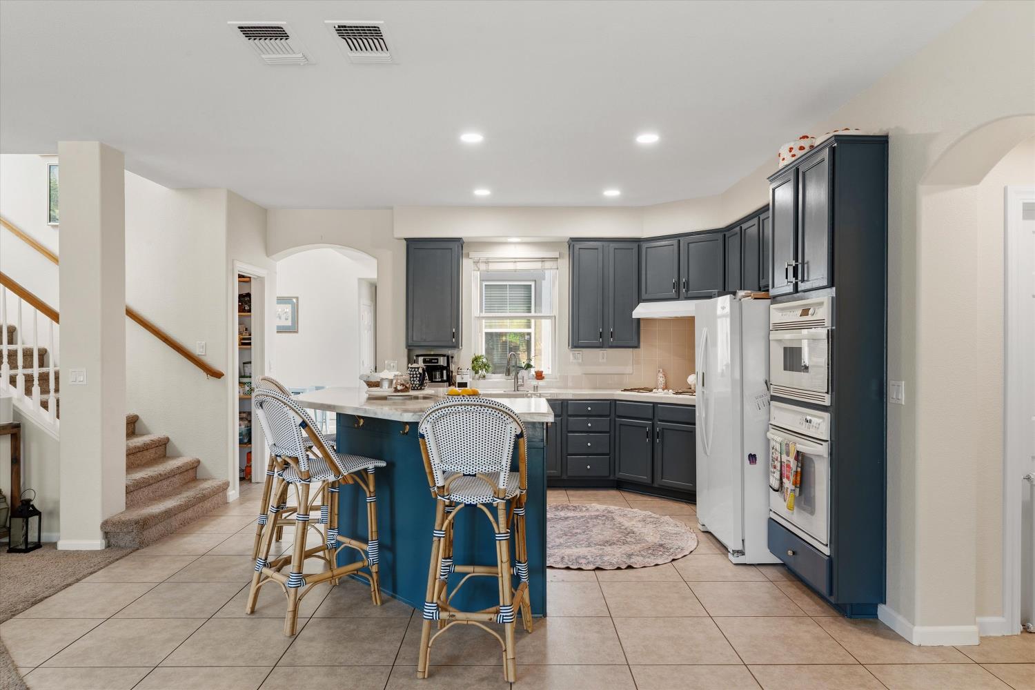 6503 Turnstone Way Rocklin, CA 95765 - Photo 17 of 42 a kitchen with stainless steel appliances kitchen island granite countertop a refrigerator and a stove top oven