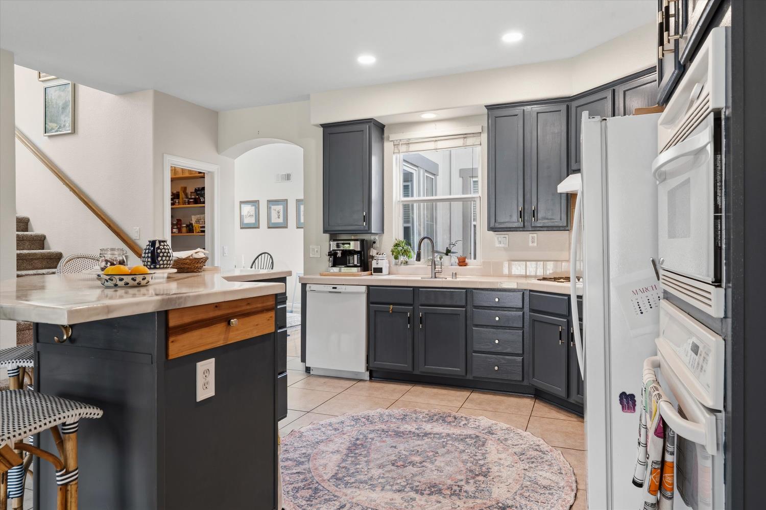 6503 Turnstone Way Rocklin, CA 95765 - Photo 18 of 42 a kitchen with stainless steel appliances granite countertop a sink stove and refrigerator