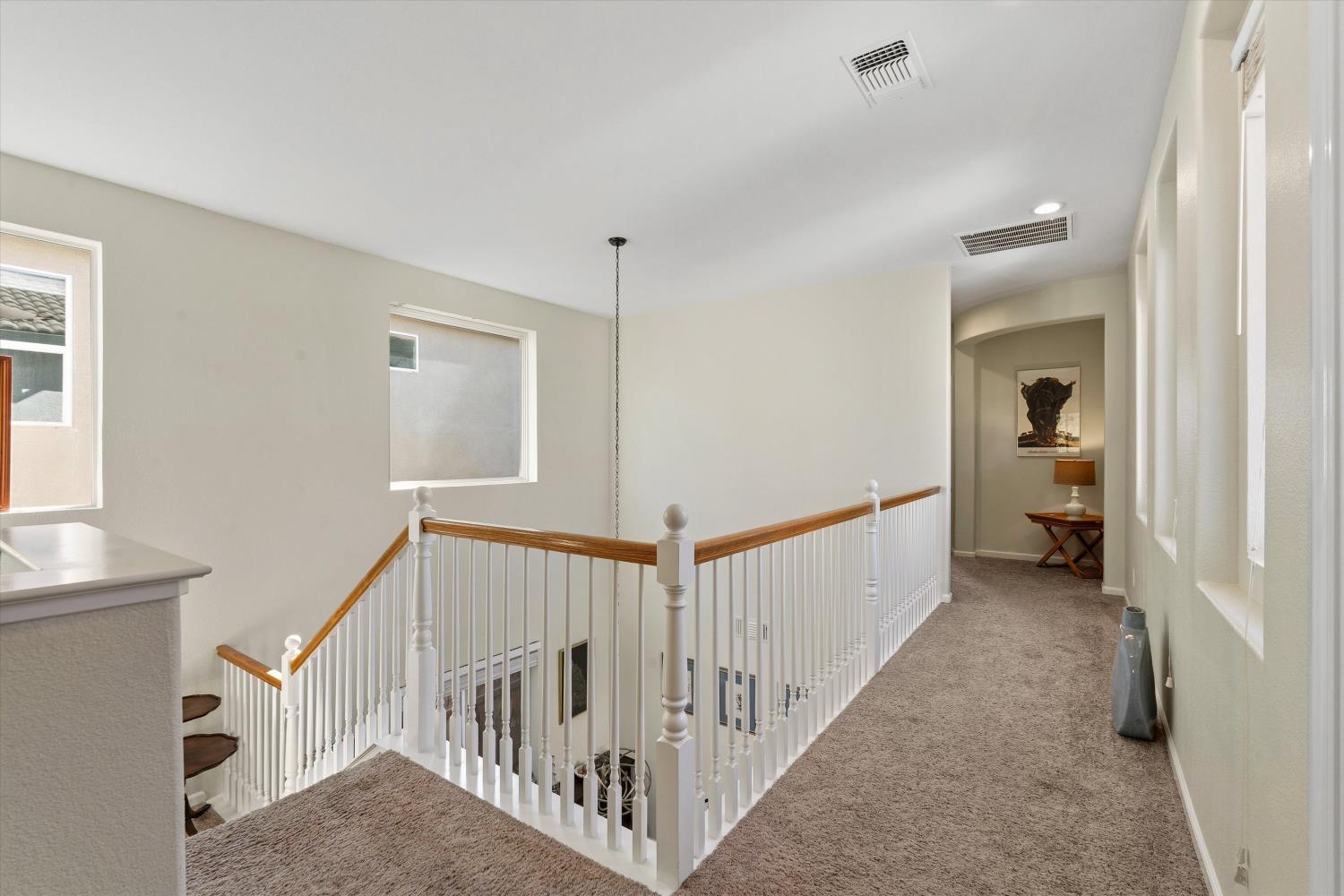 6503 Turnstone Way Rocklin, CA 95765 - Photo 23 of 42 a view of a hallway with white walls and stairs