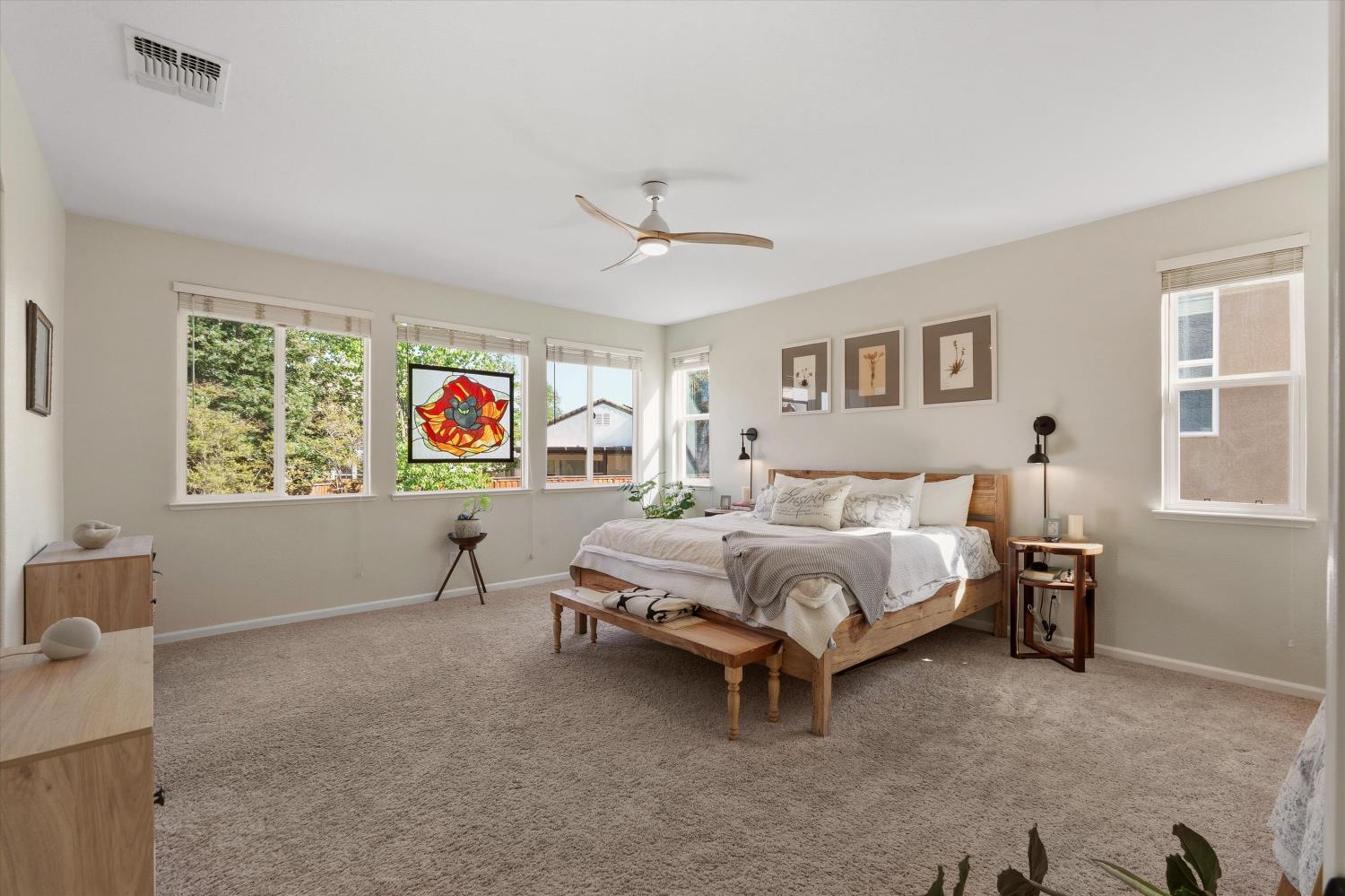 6503 Turnstone Way Rocklin, CA 95765 - Photo 24 of 42 a spacious bedroom with a bed and a window