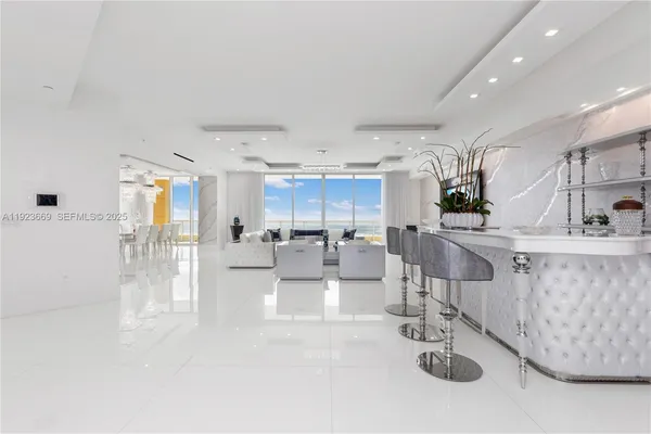 a living room with furniture and a view of kitchen