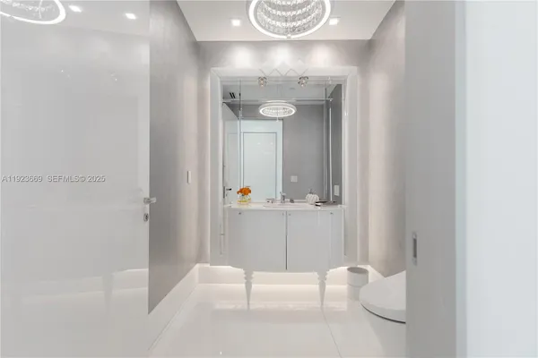 a bathroom with a granite countertop shower a toilet and a sink