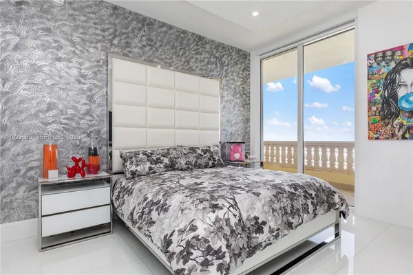 a bedroom with a large bed and window