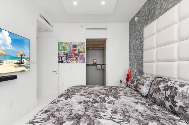 a bedroom with a bed and a chair