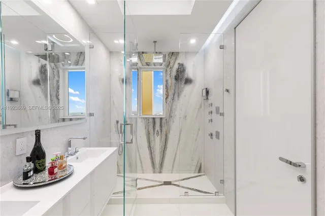 a bathroom with a sink a mirror and a bathtub