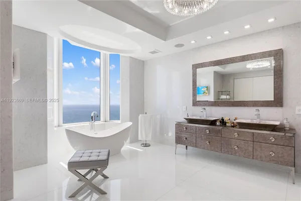 a kitchen with stainless steel appliances kitchen island granite countertop a stove a sink a dining table and chairs