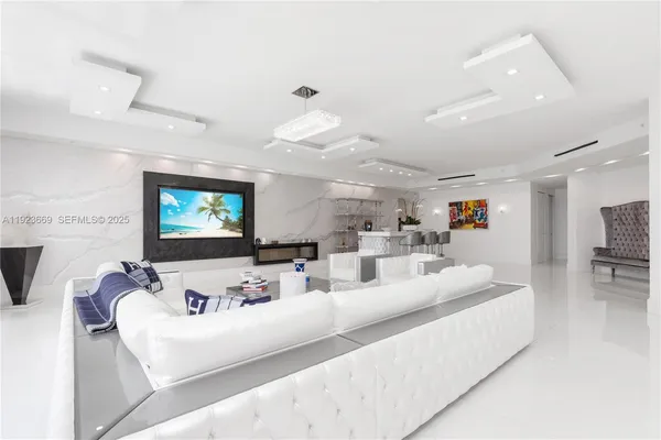 a view of a dining room with furniture and a chandelier