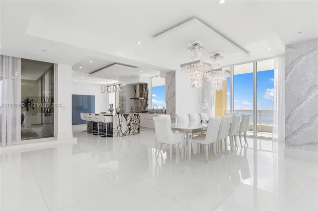 a view of a dining room with furniture and a chandelier